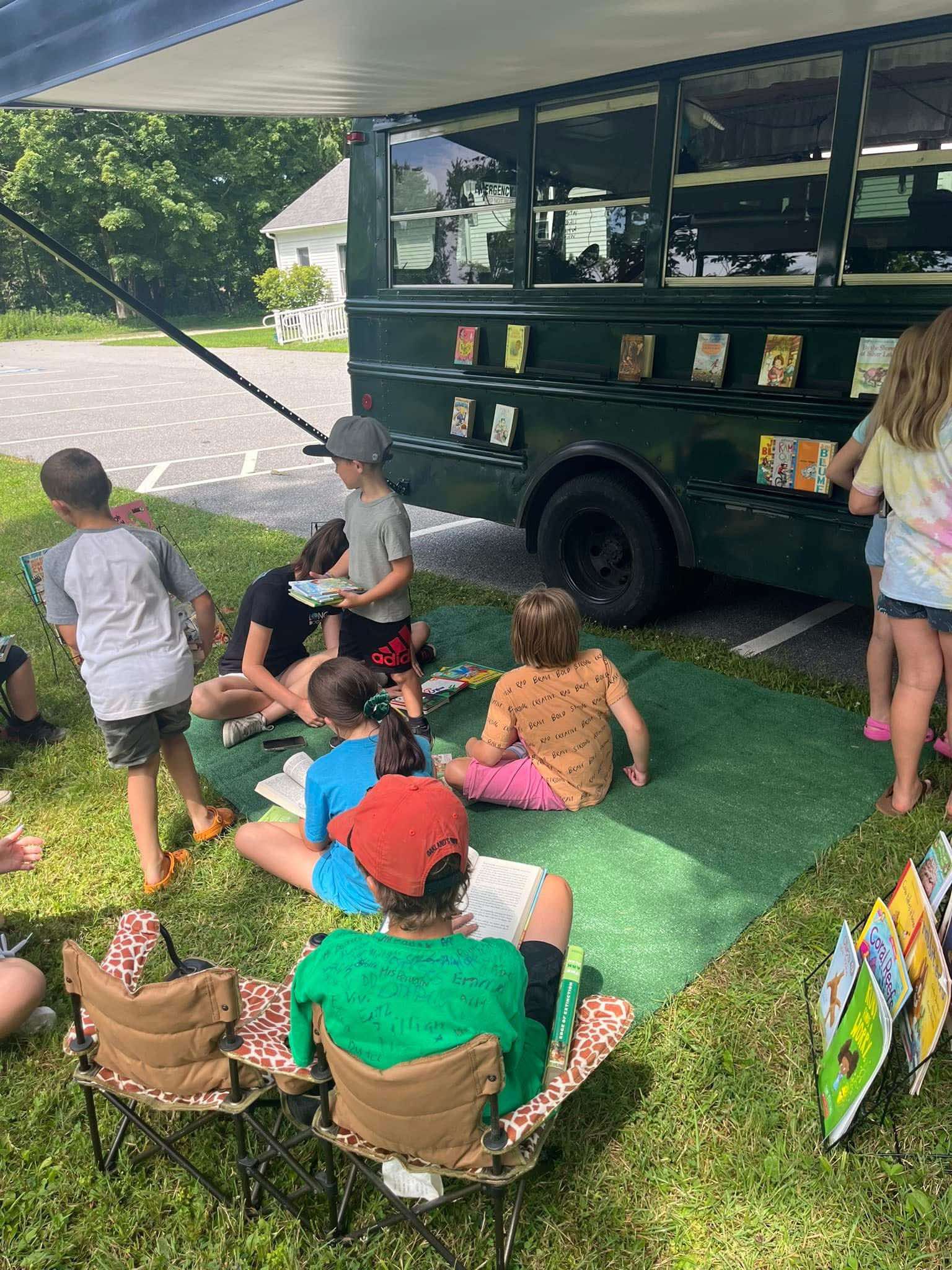 Group of children choosing books and reading