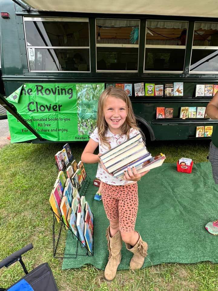 Child holding pile of books