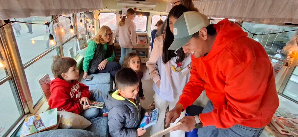 families on bus choosing books